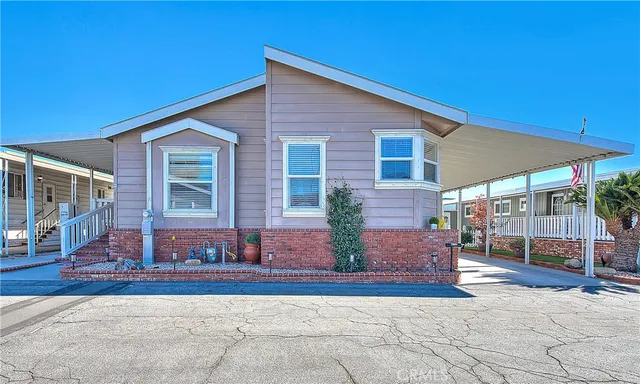 a view of a house with backyard and sitting area