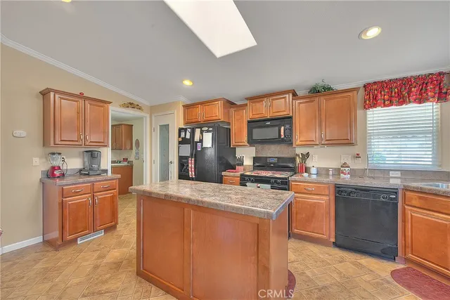 a kitchen with stainless steel appliances granite countertop a stove and a microwave