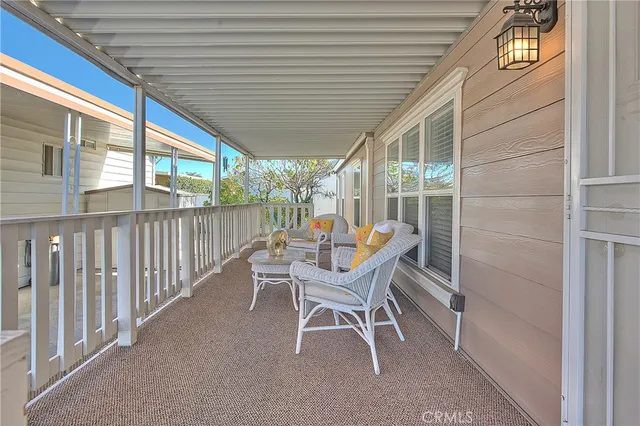 a balcony with furniture and a potted plant