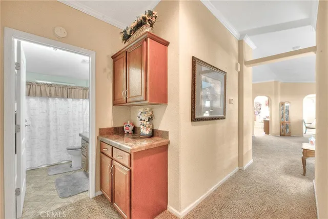 a kitchen with kitchen island granite countertop a sink and cabinets
