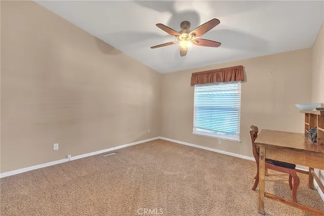 a bathroom with a granite countertop sink a toilet and a mirror