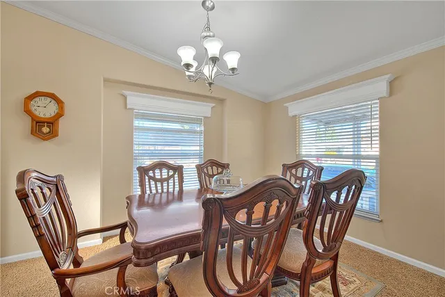 a view of a dining room with furniture wooden floor and a chandelier