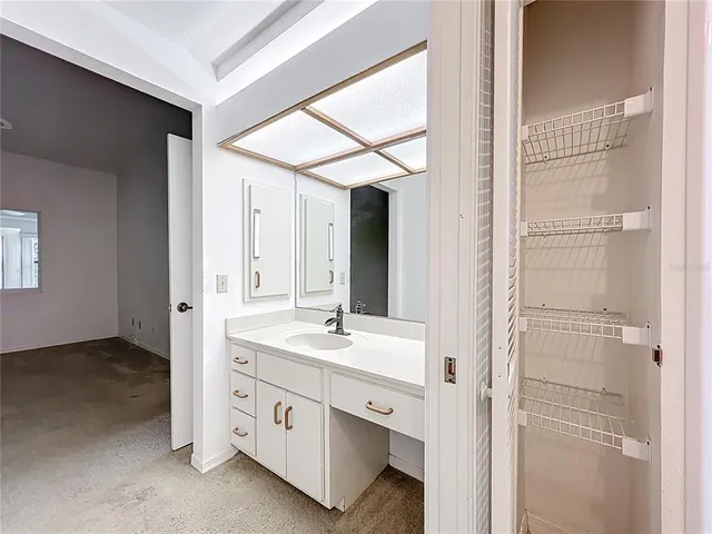a bathroom with a double vanity sink and a mirror