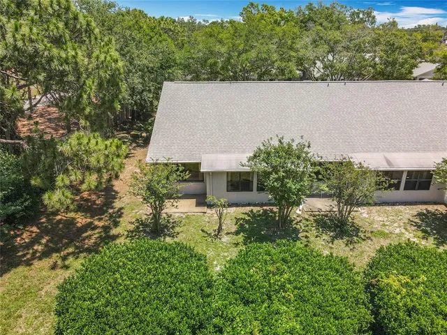 an aerial view of a house with yard and lake view