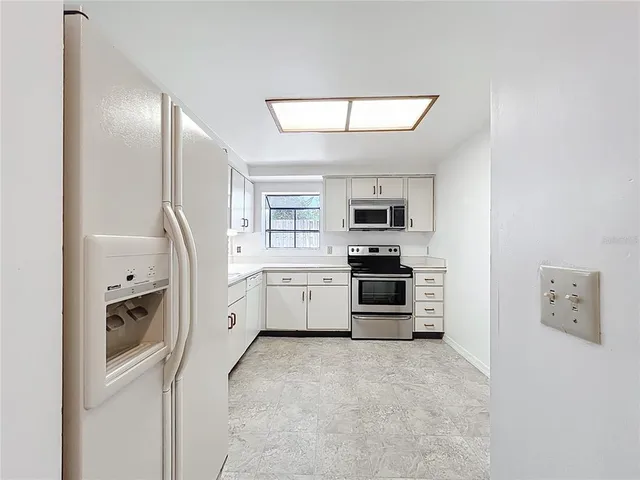 a kitchen with stainless steel appliances a refrigerator sink and stove