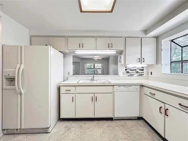 a kitchen with a sink stove and refrigerator