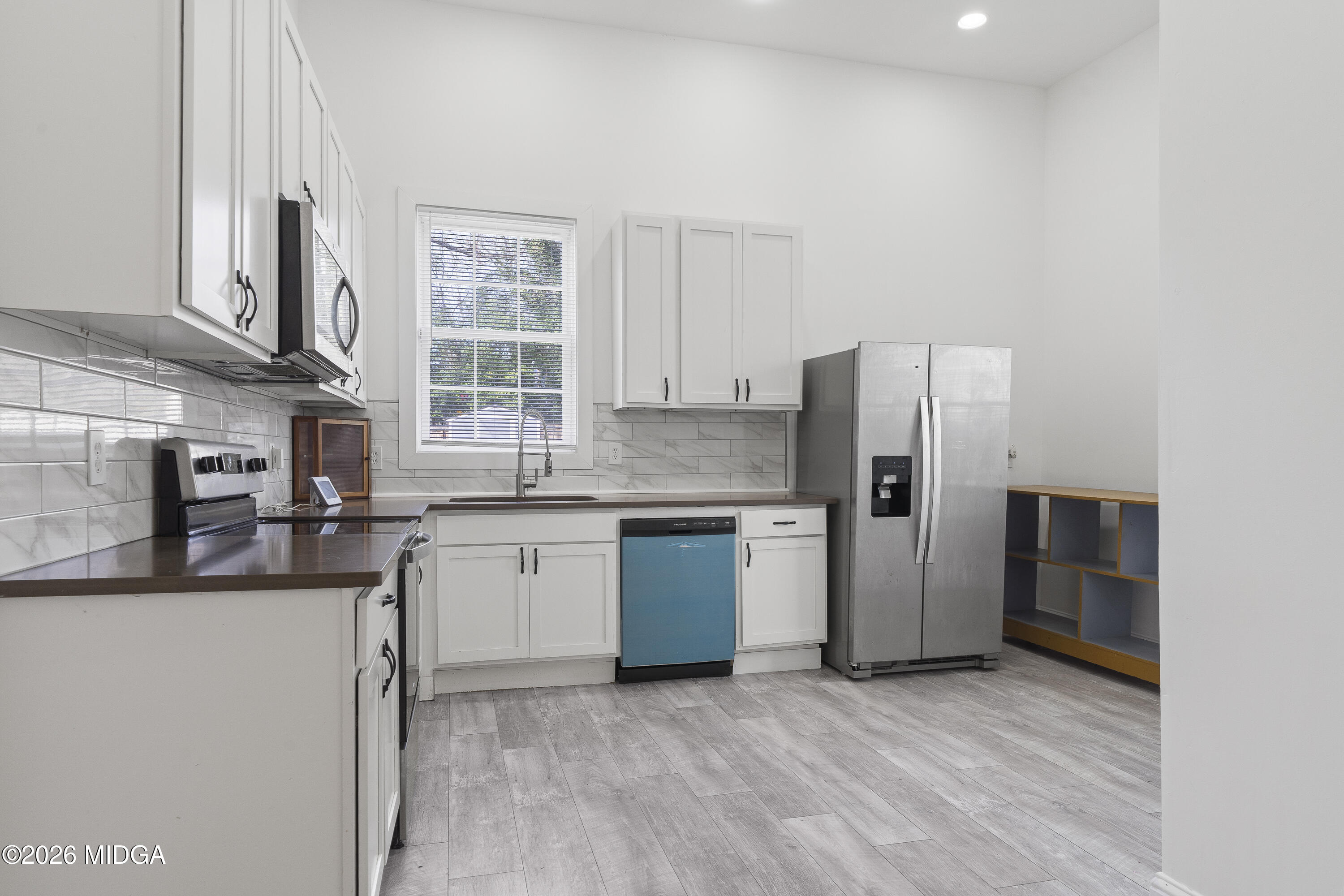 1471 Jackson Street Macon, GA 31201 - Photo 11 of 31 a kitchen with stainless steel appliances granite countertop a refrigerator and a sink