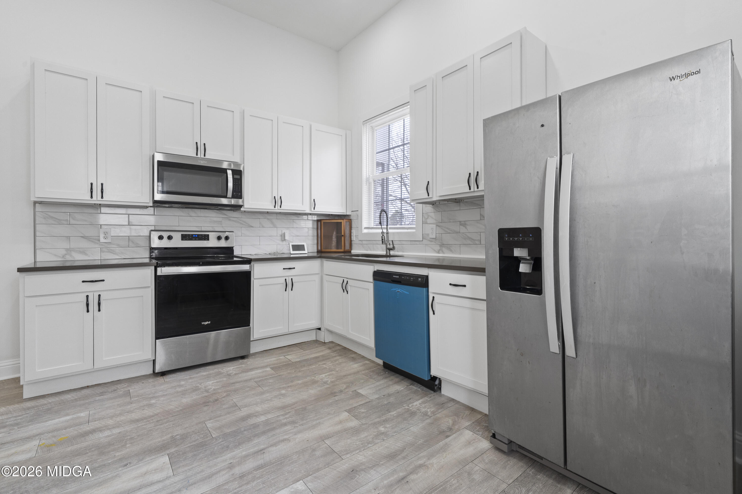 1471 Jackson Street Macon, GA 31201 - Photo 13 of 31 a kitchen with a refrigerator sink and stove top oven