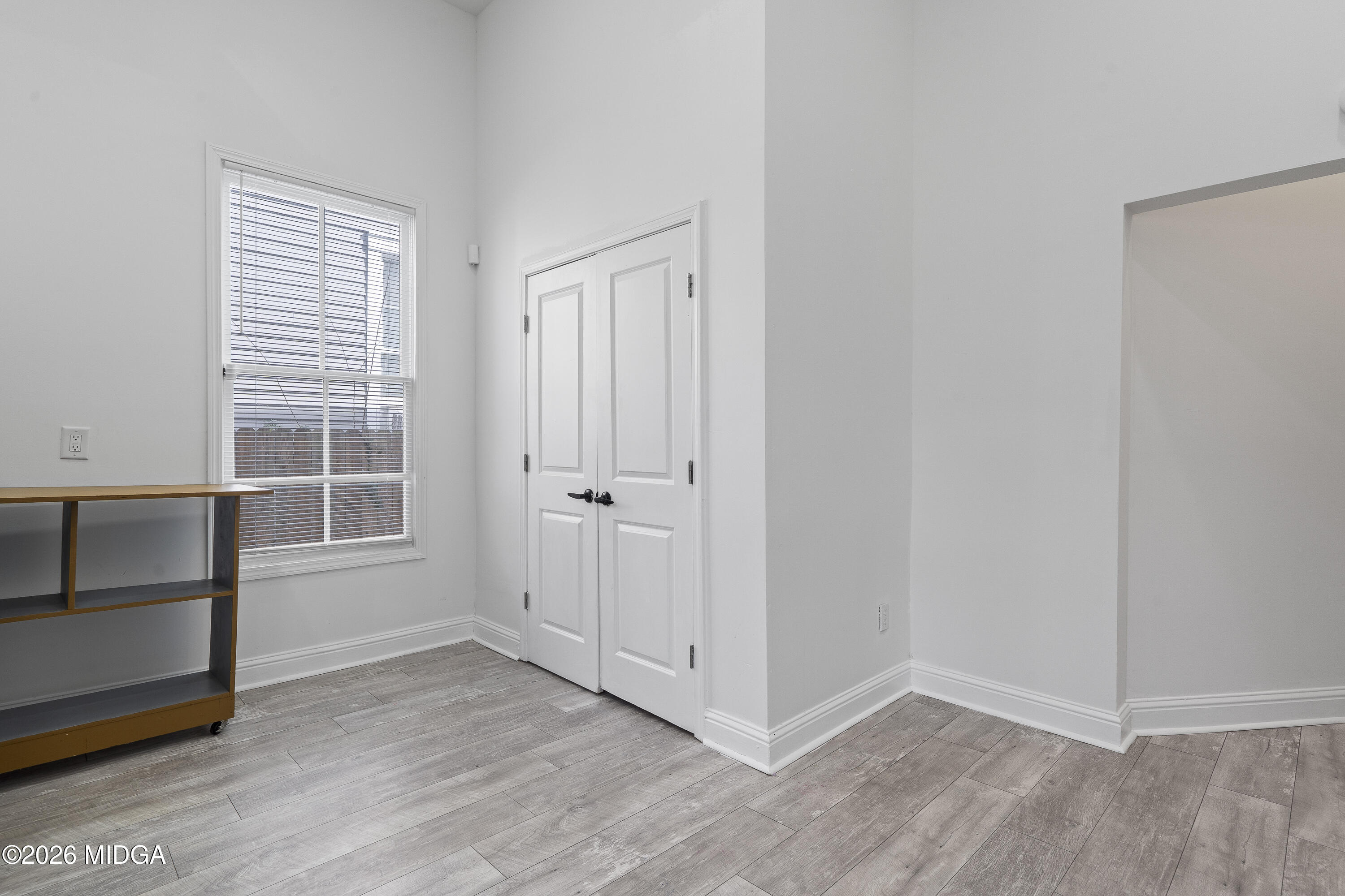 1471 Jackson Street Macon, GA 31201 - Photo 14 of 31 a view of empty room with wooden floor and window