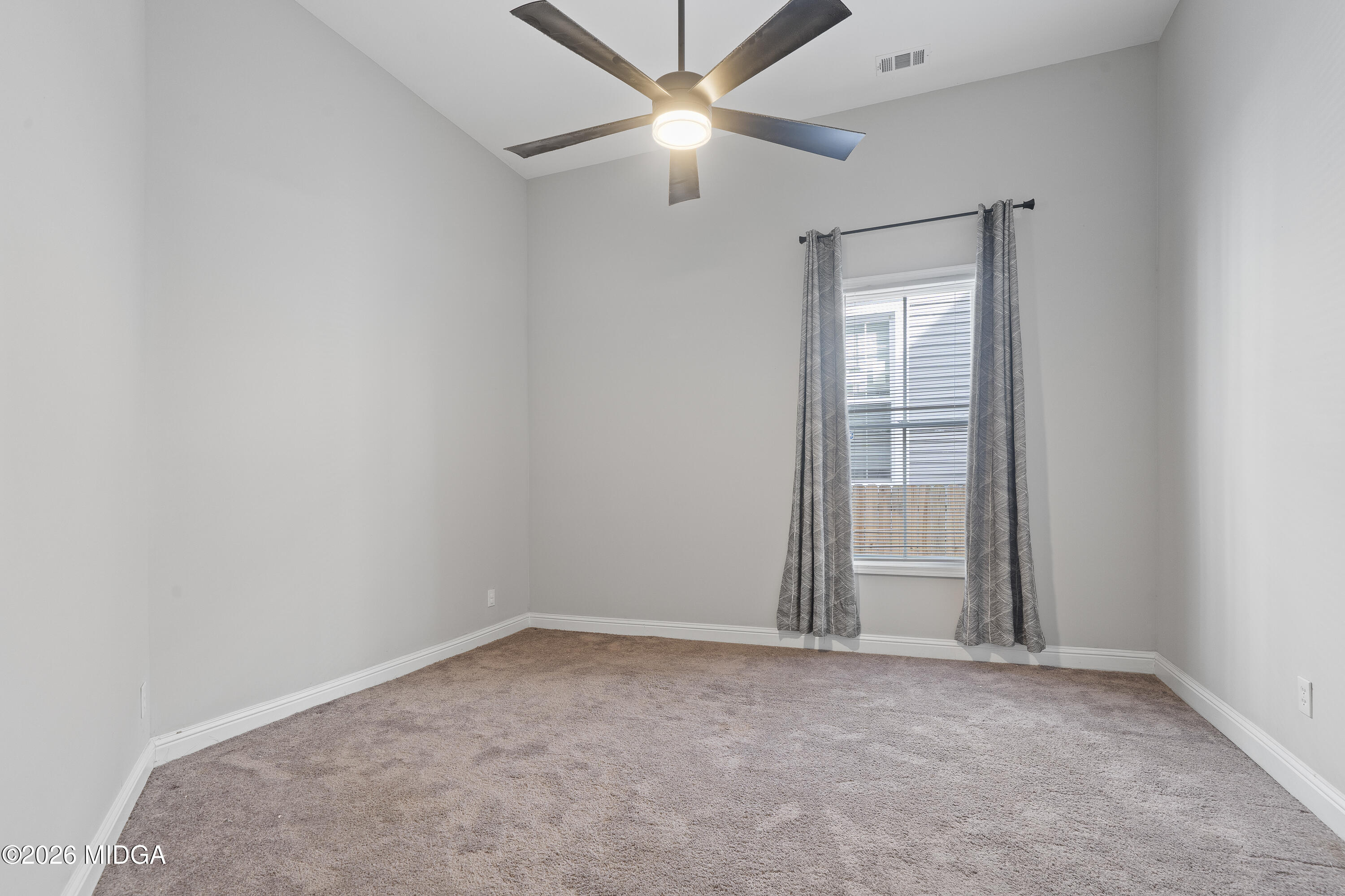 1471 Jackson Street Macon, GA 31201 - Photo 22 of 31 an empty room with closet and a ceiling fan