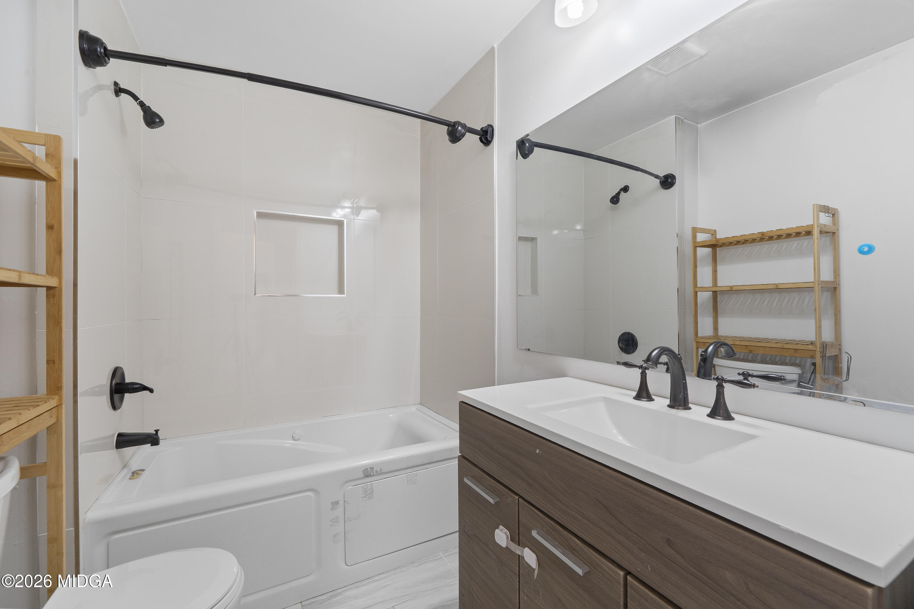 1471 Jackson Street Macon, GA 31201 - Photo 24 of 31 a bathroom with a granite countertop sink a toilet and shower