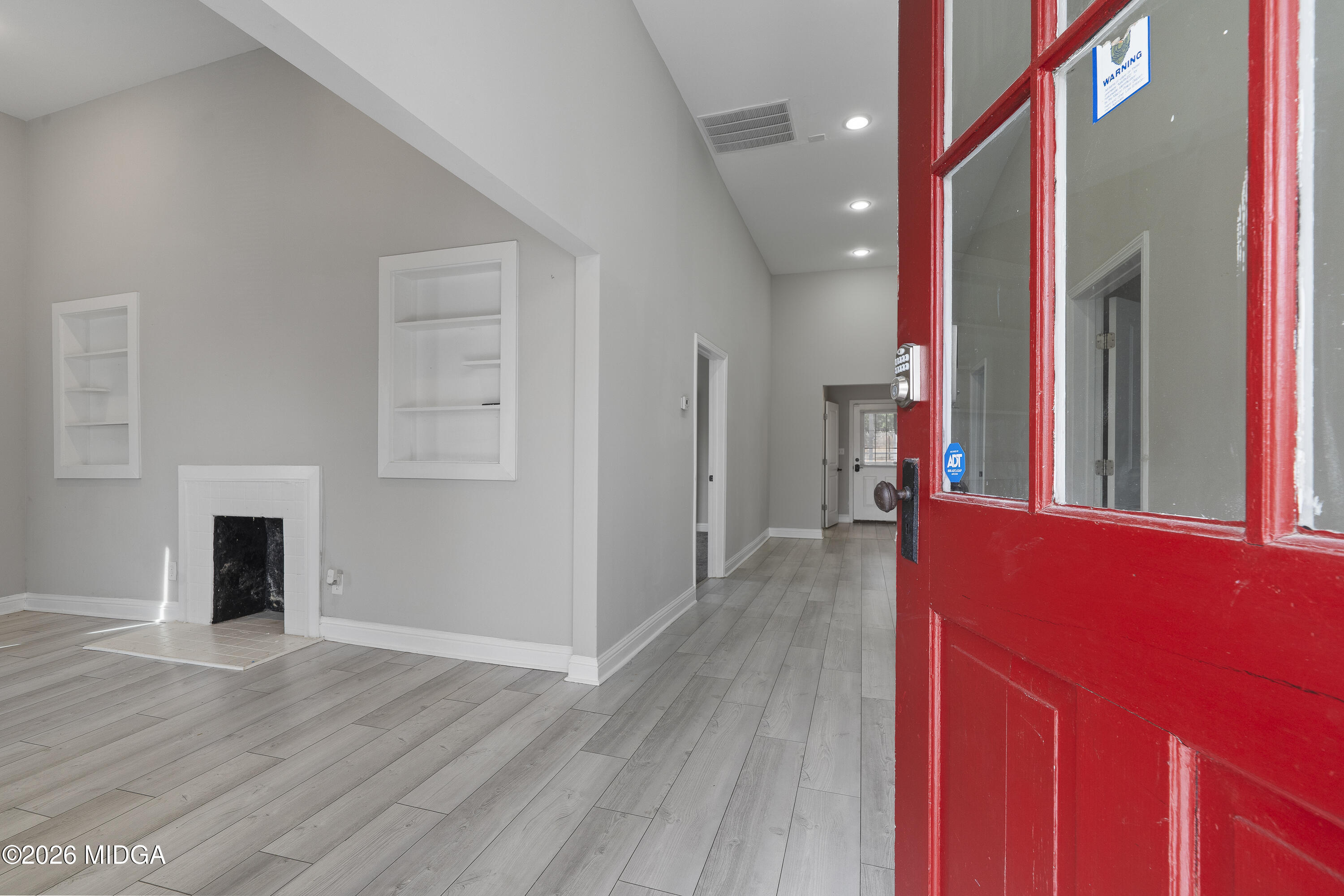 1471 Jackson Street Macon, GA 31201 - Photo 5 of 31 a view of a hallway with wooden floor and staircase