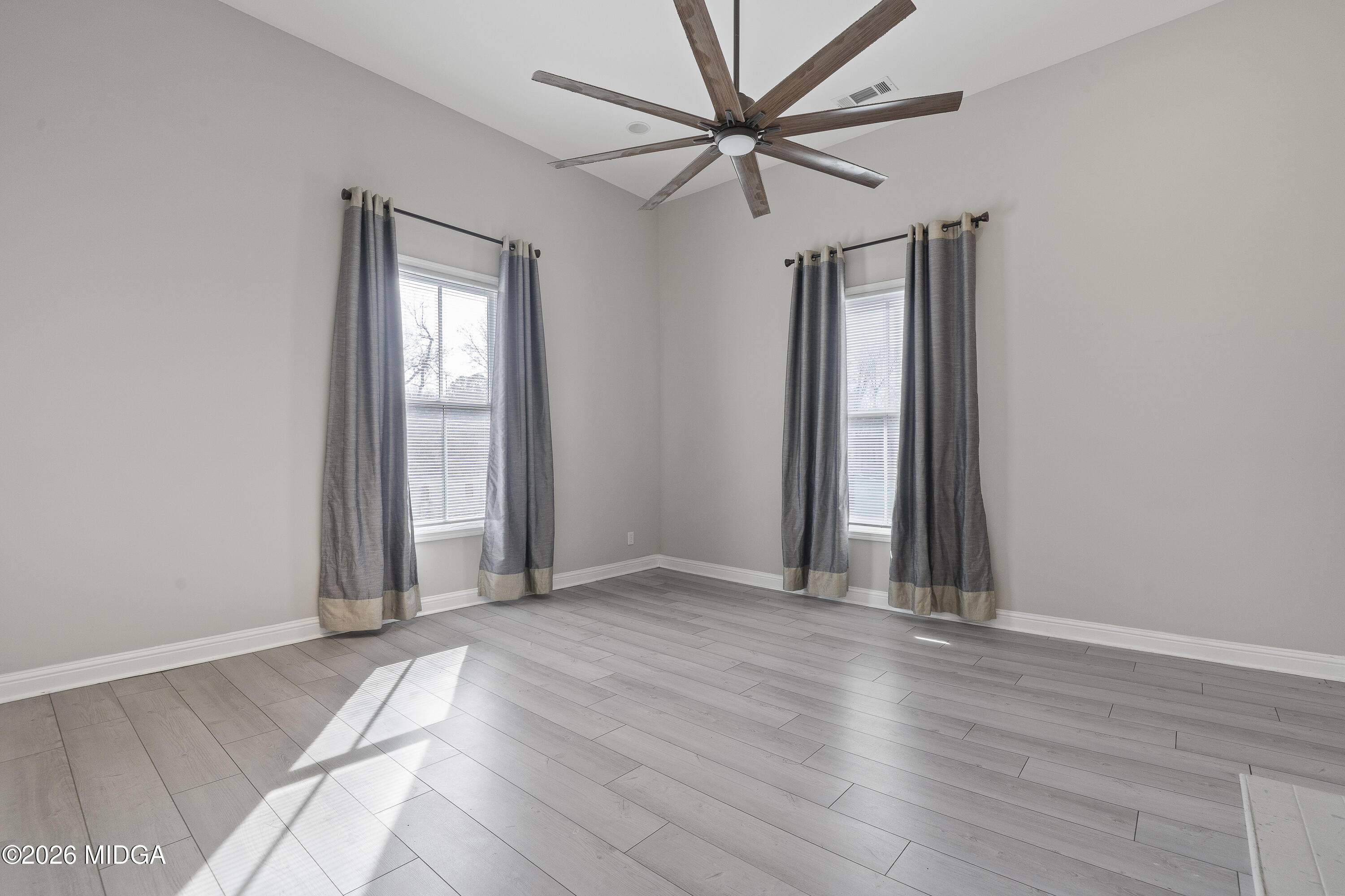 1471 Jackson Street Macon, GA 31201 - Photo 9 of 31 an empty room with wooden floor closet and windows