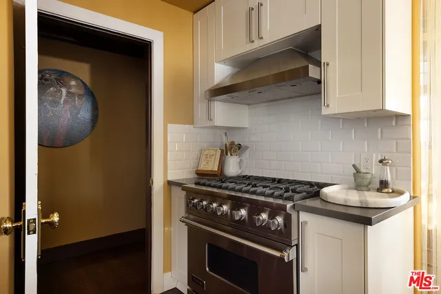 a kitchen with stainless steel appliances granite countertop a stove and a microwave