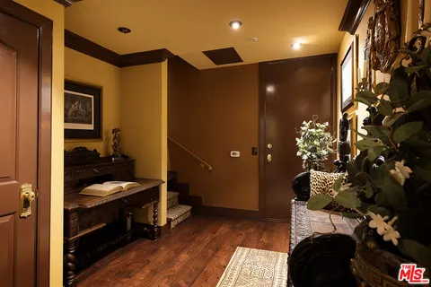 a living room with furniture and large windows