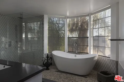 a bathroom with a bathtub and a shower
