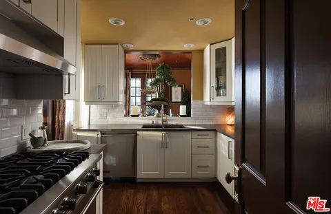 a kitchen with a sink stove and cabinets