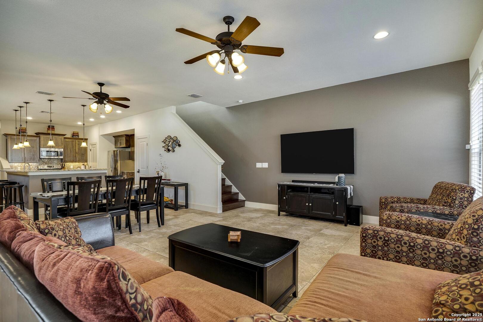 630 3 Oaks Road Seguin, TX 78155 - Photo 14 of 31 a living room with furniture kitchen view and a flat screen tv