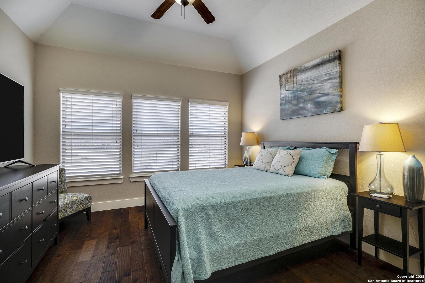 630 3 Oaks Road Seguin, TX 78155 - Photo 21 of 31 a bedroom with a bed and a flat screen tv