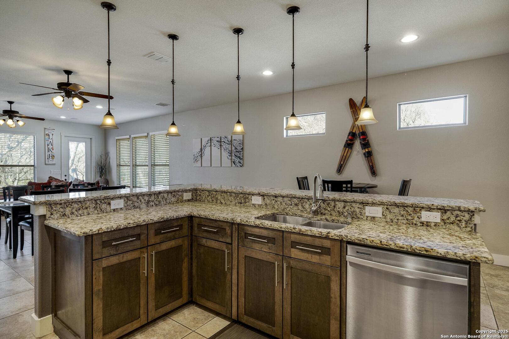 630 3 Oaks Road Seguin, TX 78155 - Photo 8 of 31 a kitchen with a sink a stove and a wooden floor