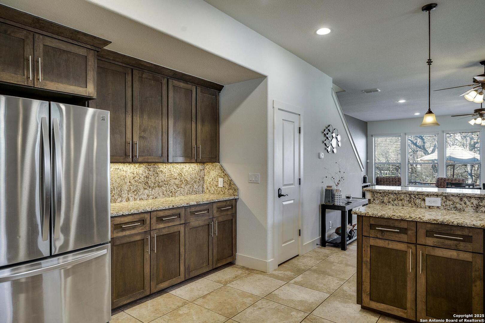 630 3 Oaks Road Seguin, TX 78155 - Photo 9 of 31 a kitchen with a sink and refrigerator