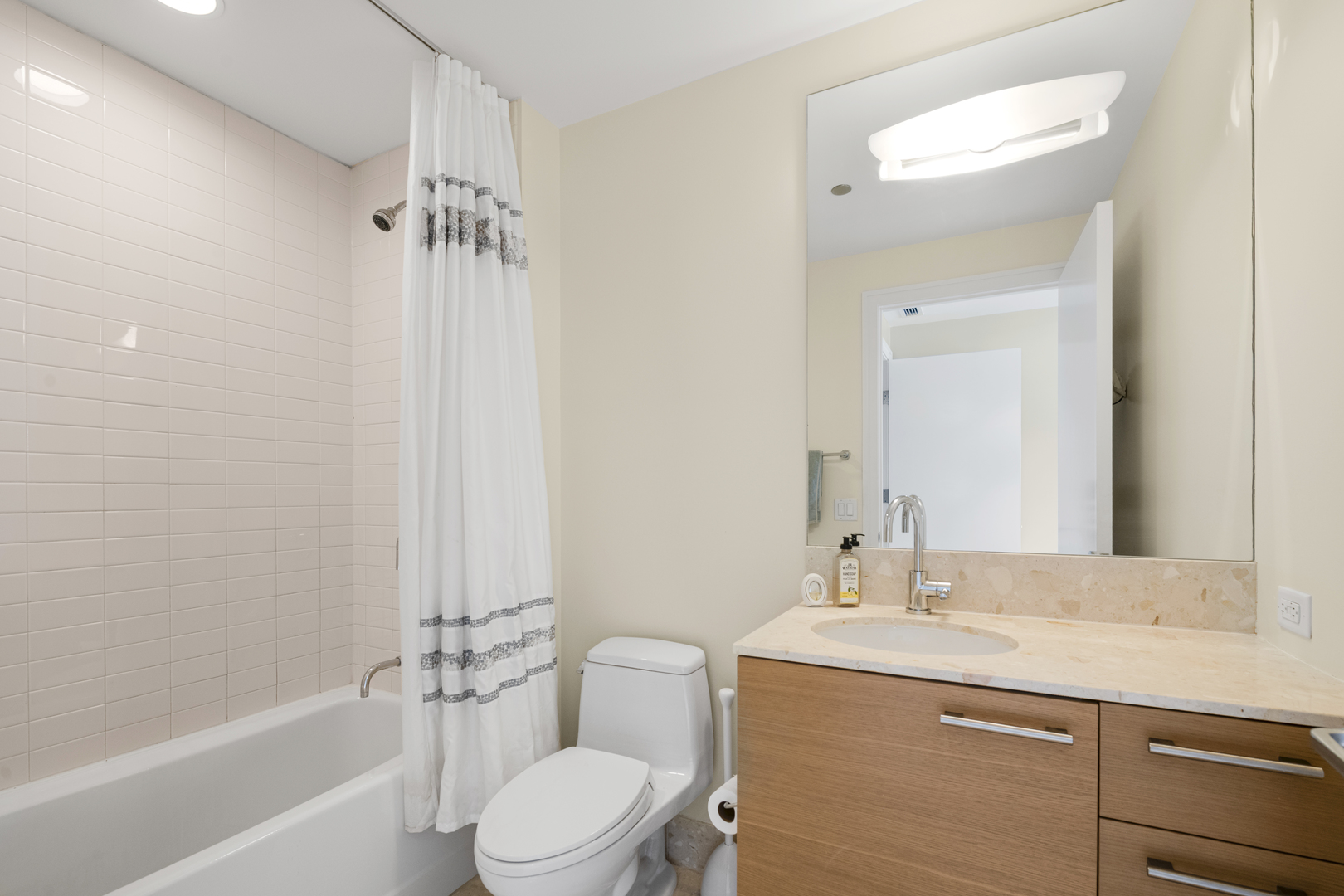 340 East Randolph Street, Unit 3304 Chicago, IL 60601 - Photo 14 of 39 a bathroom with a granite countertop sink toilet and shower