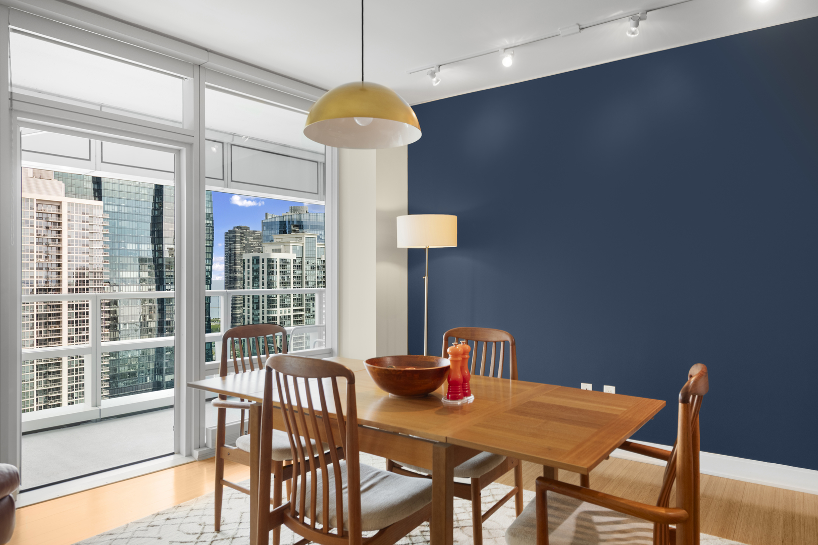 340 East Randolph Street, Unit 3304 Chicago, IL 60601 - Photo 4 of 39 a view of a dining room with furniture a chandelier and wooden floor