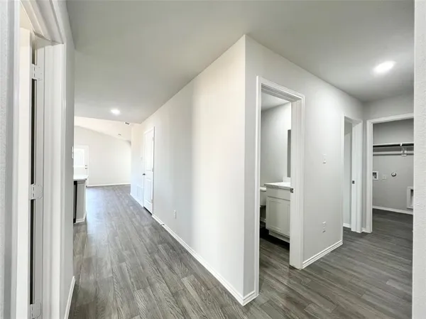 a view of a hallway with wooden floor