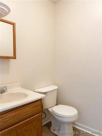 a white toilet sitting next to a bathroom sink