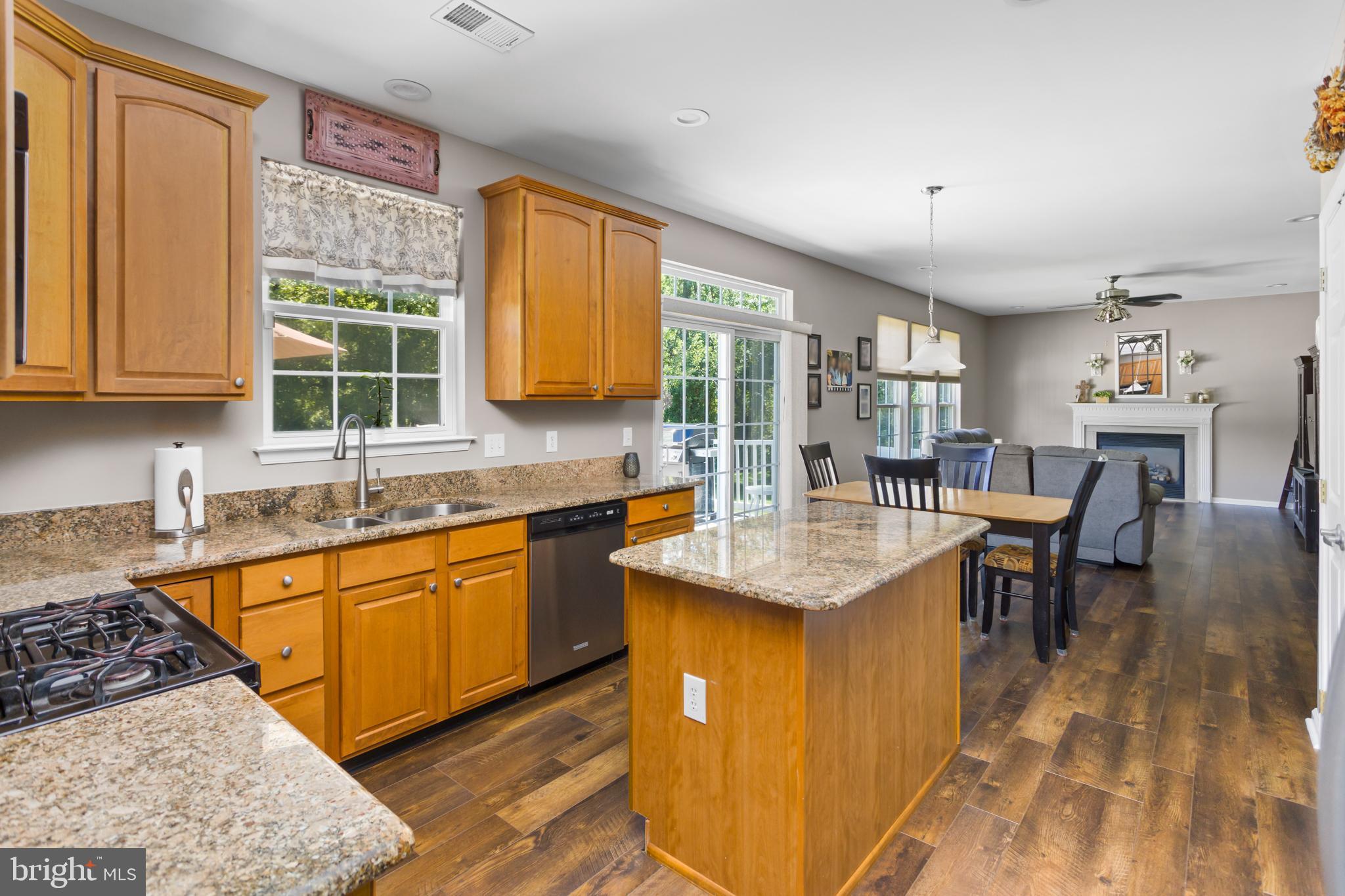 59 Birmingham Drive Columbus, NJ 08022 - Photo 16 of 45 a kitchen with granite countertop kitchen island stainless steel appliances a table chairs sink and cabinets