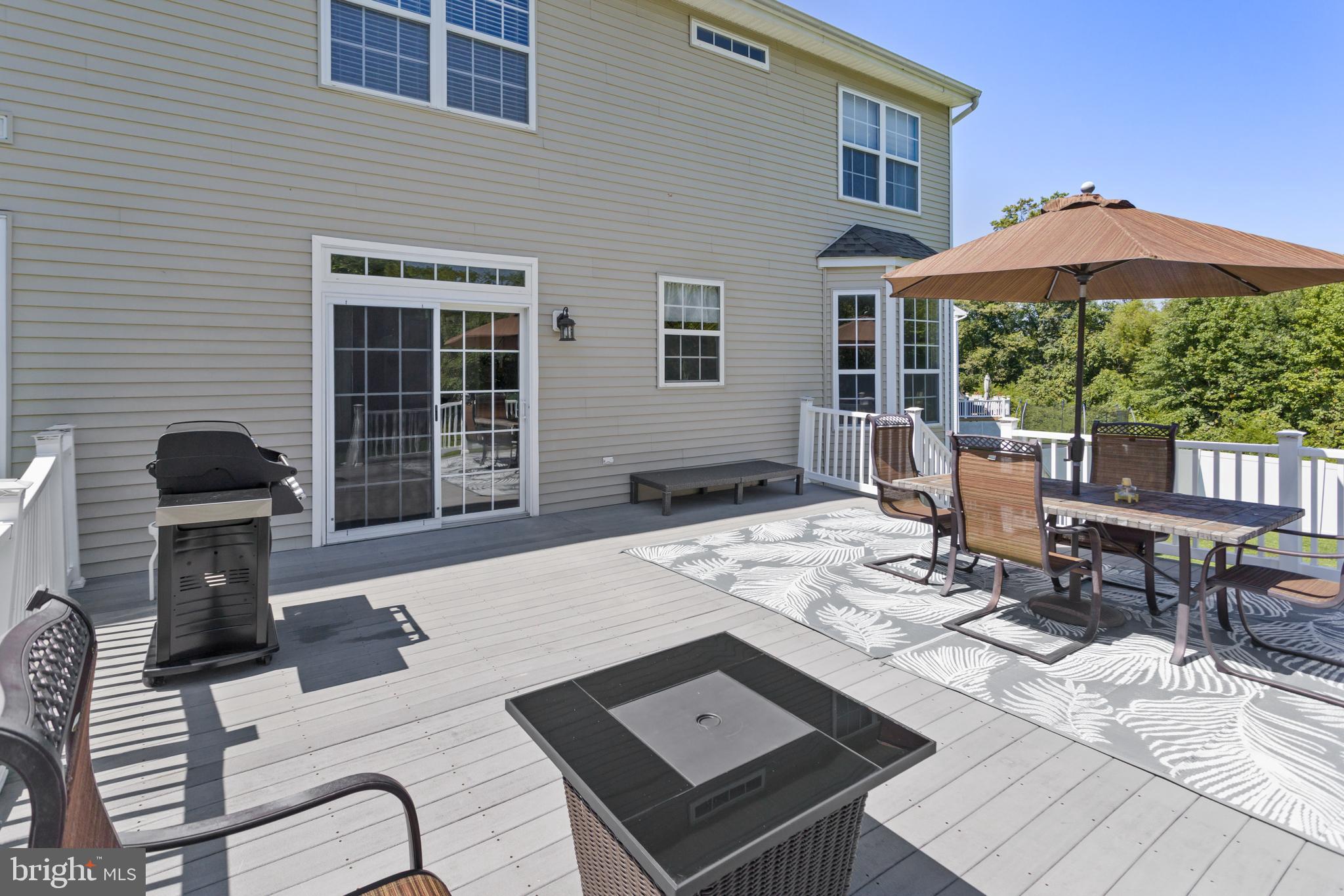 59 Birmingham Drive Columbus, NJ 08022 - Photo 39 of 45 a view of a patio with a dining table and chairs with wooden floor