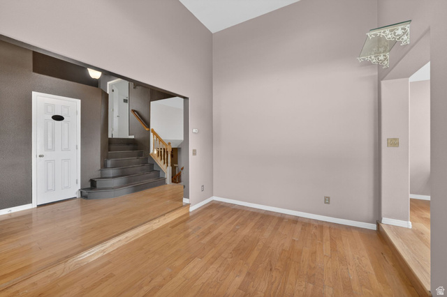 1464 990 West Provo, UT 84601 - Photo 3 of 41 Sunken living area featuring light wood-finish flooring, vaulted ceilings, and a decorative wall shelf
