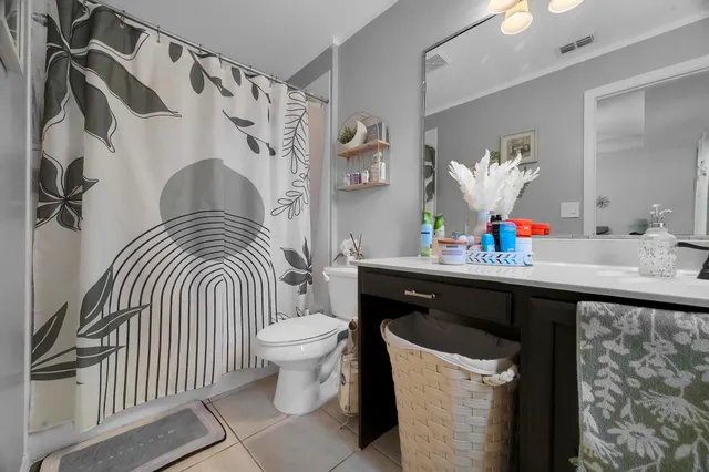 a bedroom with a bed a couch and a flat screen tv