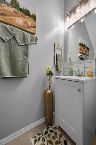 a bathroom with a sink toilet and a mirror