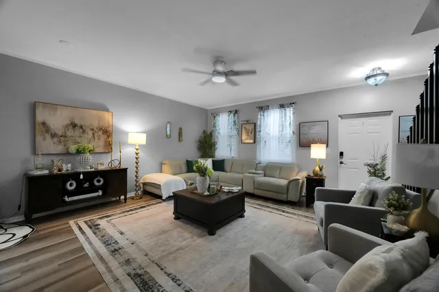 a living room with furniture a flat screen tv and a fireplace