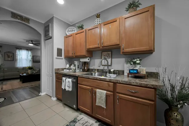 a kitchen with stainless steel appliances granite countertop a refrigerator stove and sink