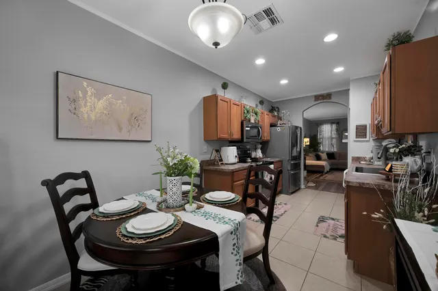 a view of a dining room with furniture and a chandelier