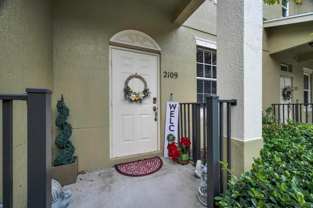 a front view of a house with a yard and a garage