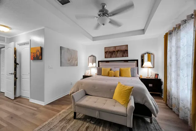 a bedroom with a bed and wooden floor