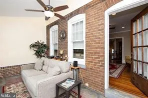 a living room with furniture fireplace and a rug