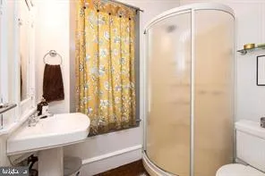 a bathroom with a sink toilet and shower
