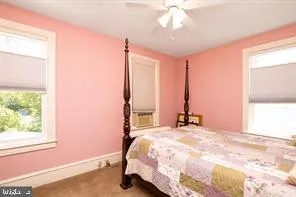 a bed sitting in a bedroom next to a window