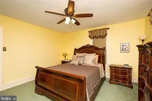 a bedroom with a bed and ceiling fan
