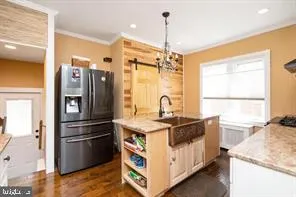 a kitchen with stainless steel appliances granite countertop a sink a stove and a refrigerator