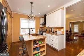 a kitchen with kitchen island granite countertop a sink cabinets and window