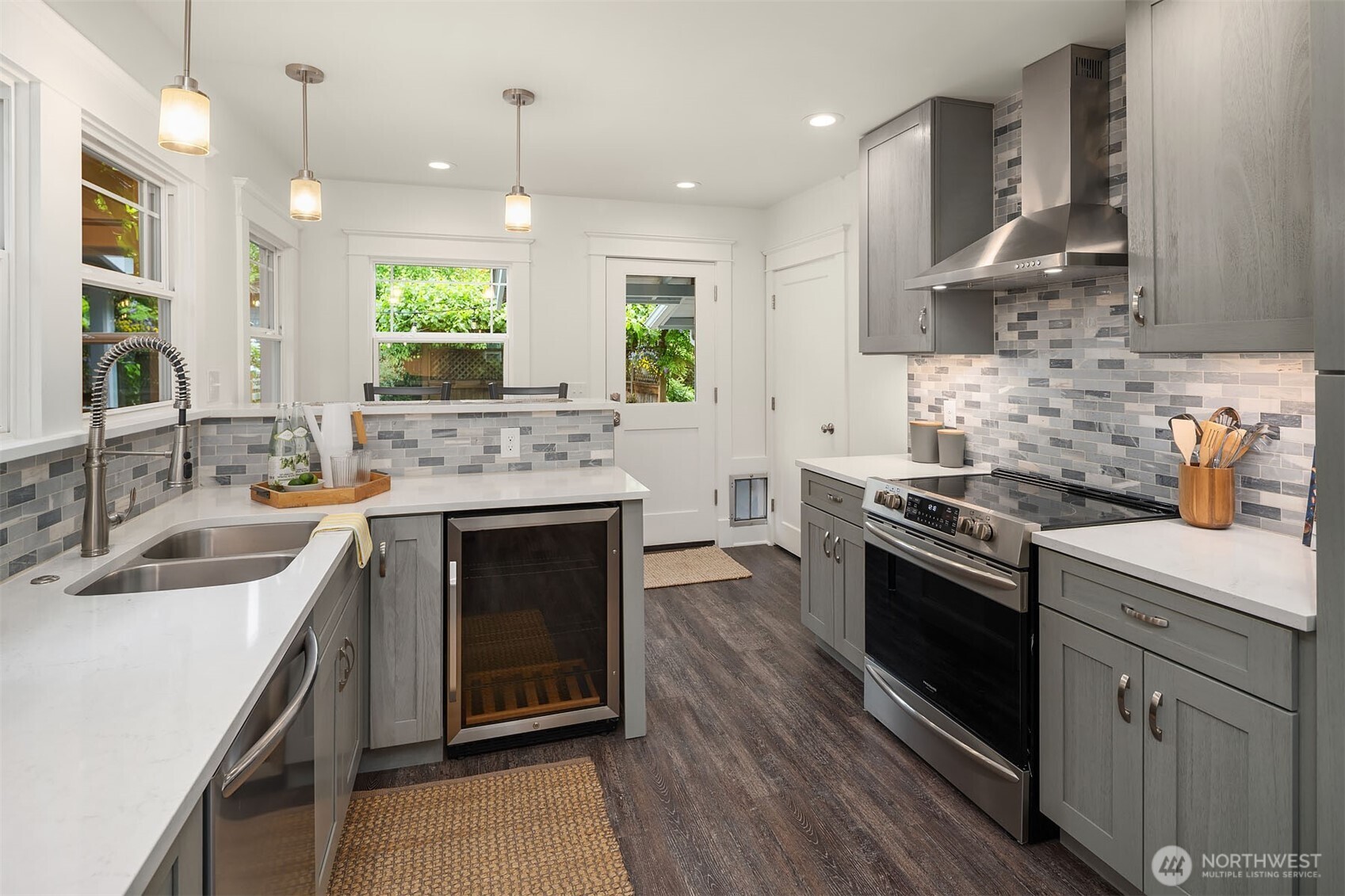 519 27th Avenue Seattle, WA 98122 - Photo 9 of 38 a kitchen with stainless steel appliances granite countertop a sink stove and cabinets