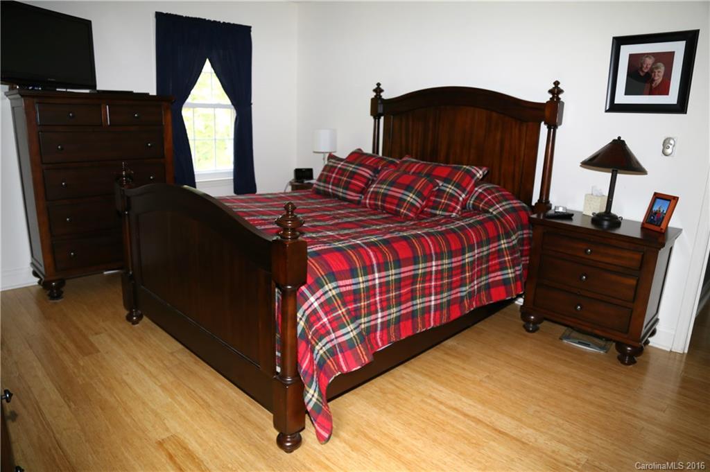 113 Sawtooth Lane, Unit 27 Stanley, NC 28164 - Photo 14 of 24 a bedroom with a bed and a mirror