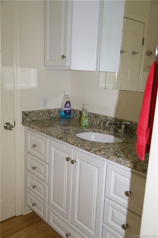113 Sawtooth Lane, Unit 27 Stanley, NC 28164 - Photo 15 of 24 a kitchen with granite countertop white cabinets and sink