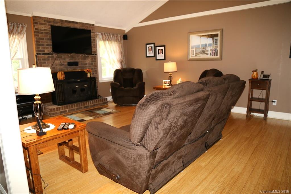 113 Sawtooth Lane, Unit 27 Stanley, NC 28164 - Photo 7 of 24 a living room with furniture and a flat screen tv