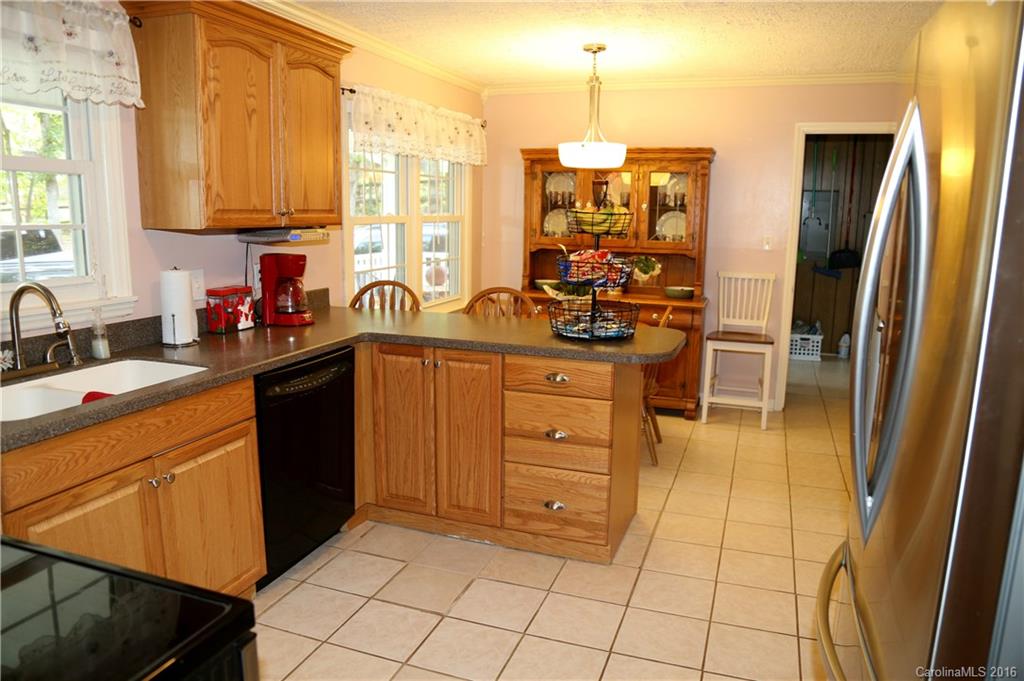 113 Sawtooth Lane, Unit 27 Stanley, NC 28164 - Photo 10 of 24 a kitchen with stainless steel appliances a sink cabinets and wooden floor